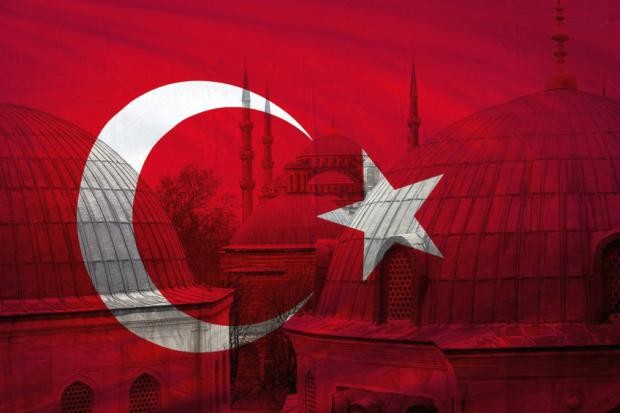 Turkish flag with mosque in background - Stock photo