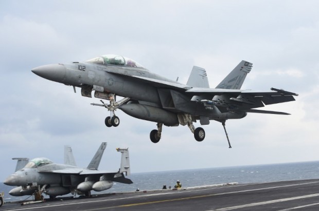 This picture taken on March 14, 2017 shows a two-seater F/A-18F Super Hornet landing on the deck of the Nimitz-class aircraft carrier USS Carl Vinson during a South Korea-US joint military cxercise in seas east of the Korean Peninsula.  The nuclear-powered US aircraft carrier on March 15 arrived in South Korea to participate in an ongoing joint military exercise, the US navy said, as the latest show of force against North Korea. / AFP PHOTO / JUNG Yeon-Je