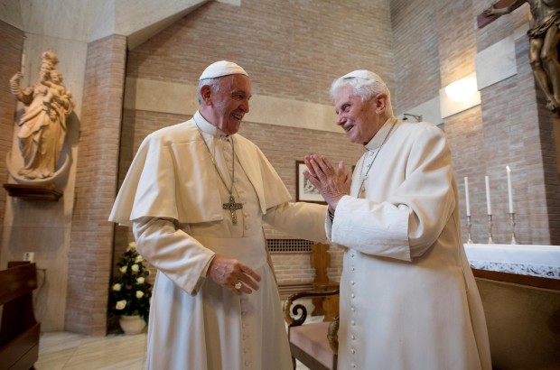 FILE - In this Saturday, Nov. 19, 2016 filer, Pope Francis, left, talks with Pope Emeritus Benedict XVI in the former Convent Mater Ecclesiae at the Vatican. A "modest" 90th birthday party is being planned for Benedict XVI, who stunned the Catholic church by resigning in 2013. His aide, Monsignor Georg Gaenswein, says Benedict's birthday, which falls on Easter Sunday this year, will be celebrated on Monday in Bavarian style in keeping with the emeritus pontiff's roots. (L'Osservatore Romano/Pool Photo via AP)