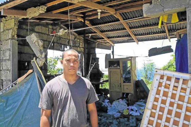 Jeffrey Yrabon, 35, poses in front of the wreckage of his house on the hills of Barangay Bagalangit in Mabini town, Batangas, which was near the epicenter of the quake. —CHRIS QUINTANA/CONTRIBUTOR
