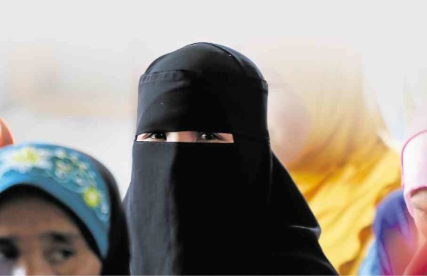 A MUSLIM woman wears a burqa inside a camp of the Moro Islamic Liberation Front in Maguindanao province. Inquirer file photo