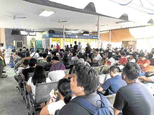 LONG WAIT. Patients wait to be called at the Philippine Charity Sweepstakes Office (PCSO). 
