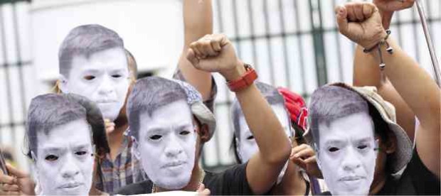 Protesters wear masks representing Jonas Burgos at Camp Aguinaldo to demand military accountability for his disappearance. Burgos remains missing 10 years after he was abducted by suspects believed to be military men. The official being blamed by activists for Burgos’ disappearance, Eduardo Año, was intelligence chief at the time and is now armed forces chief.—NIÑO JESUS ORBETA