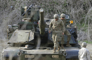 U.S. Army soldiers on a M1A2 tank conduct a military exercise in Paju, near the border with North Korea, South Korea, Friday, April 21, 2017. The U.N. Security Council threatened new sanctions against North Korea Thursday in a strongly-worded condemnation of its latest missile launch after the U.S. agreed to a Russian request to include a call for "dialogue" with Pyongyang. (AP Photo/Ahn Young-joon)