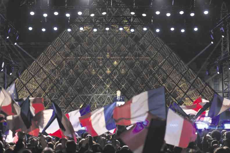 POLL VICTOR French President-elect Emmanuel Macron, who defeated Marine Le Pen, addresses the crowd in front of the Louvre Museum Pyramid in Paris. —AFP
