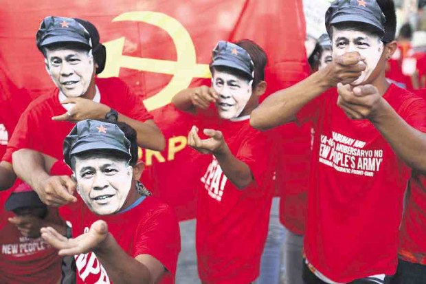 New People’s Army supporters, wearing masks of “Kumander Parago,” join a rally in Davao City. —Karlos Manlupig