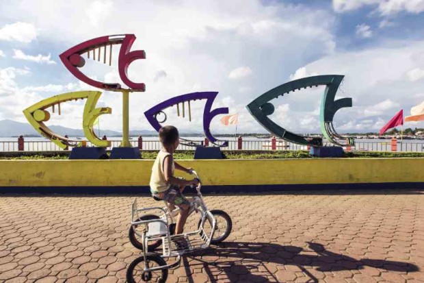 A boy enjoys a bike ride at Puerto Princesa City’s baywalk. —LEO SABANGAN II