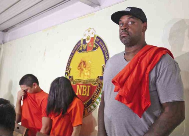 Former professional basketball player Dorian Peña (right), along with Jose Paolo Ampeso and his live-in partner Ledy Mea Vilchez, is presented at the National Bureau of Investigation following their arrest on May 9. —MARIANNE BERMUDEZ