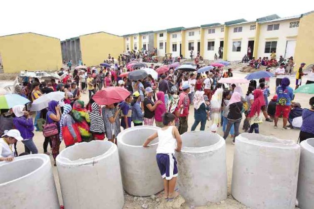 Members of the urban poor group Kadamay gather at a government housing site in Pandi town, Bulacan province, for a validation process conducted by the National Housing Authority.  —NIÑO JESUS ORBETA