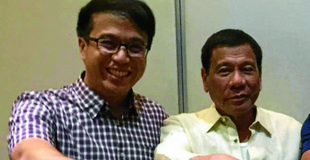 Lawyer Mark Kristopher Tolentino (left) poses with President Duterte.