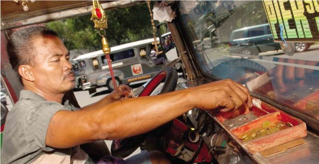 TIME TO DECLUTTER  Jeepney drivers like him, who has both a Chinese good luck charm and a rosary as “protection” against untoward incidents on the road, better clear their view of such items by Friday, according to an official of the Land Transportation Franchising and Regulatory Board.—REM ZAMORA