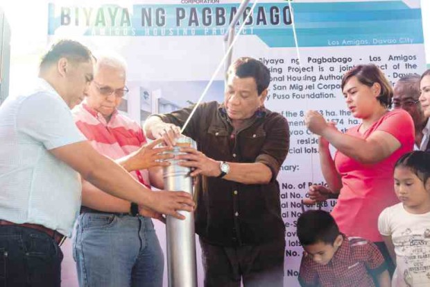 President Duterte, joined by Cabinet Secretary Leoncio Evasco Jr. (second from left) and Davao City Mayor Sara Duterte (right), leads the groundbreaking ceremony for  Biyaya ng Pagbabago housing project. —MALACAÑANG PHOTO