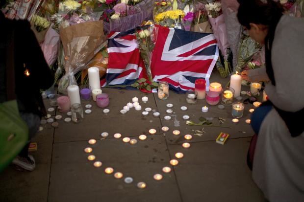 British flag with flowers and candles at Manchester vigil - 23 May 2017