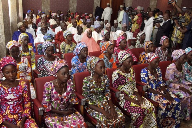 (FILES) This file photo taken on October 19, 2016 shows 21 Chibok girls who were released by Boko Haram a week before, attending a meeting with the Nigerian President at the State House in Abuja, Nigeria.  At least 80 schoolgirls who were among more than 200 kidnapped by Boko Haram in northeast Nigeria in 2014 have been released, security sources, a senior minister and the father of two of them told AFP on May 6, 2017. / AFP PHOTO / Philip OJISUA