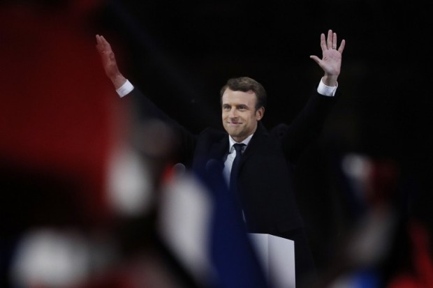French president-elect Emmanuel Macron waves to the crowd as he delivers a speech at the Pyramid at the Louvre Museum in Paris on May 7, 2017, after the second round of the French presidential election. Emmanuel Macron was elected French president on May 7, 2017 in a resounding victory over far-right Front National (FN - National Front) rival after a deeply divisive campaign, initial estimates showed. / AFP PHOTO / Patrick KOVARIK