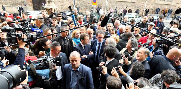 French centrsit presidential election candidate Emmanuel Macron, center, is surrounded by reporters as he visits at the Compagnons du Devoir house in Rodez, southern France, Friday, May 5, 2017. On the last day of France's presidential campaign, centrist candidate Emmanuel Macron mingled with the crowd in the small streets of the southwestern town of Rodez. (Jose A. Torres, Pool via AP)
