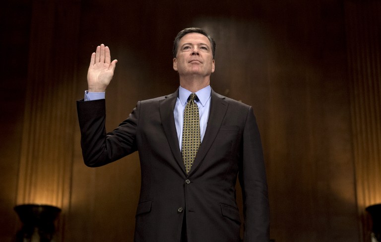 This file photo taken on May 3, 2017 shows  FBI Director James Comey sworn in prior to testifying before the Senate Judiciary Committee on Capitol Hill in Washington, DC. US President Donald Trump asked former FBI director Comey to drop an investigation of his national security advisor Michael Flynn, the New York Times reported on May 16, 2017. In an explosive new report that was immediately denied by the Trump administration, the Times said Comey met the president in the White House on February 14, later summing up their discussion of Flynn in a memo. / AFP PHOTO / JIM WATSON