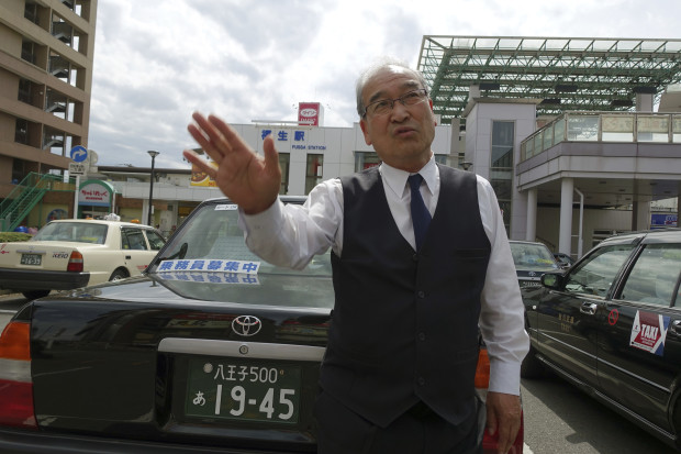 In this Thursday, April 27, 2017, photo, taxi driver Seijiro Kurosawa, 58, speaks during an interview with The Associated Press in front of Fussa Station in Fussa where the Yokota Air Base is located in Tokyo's western suburbs. Residents living near U.S. military bases in Japan are facing a fresh reality: Their neighborhoods are on the frontline of North Korea’s dispute with America and if Pyongyang were to attack they would have just several minutes to shelter from incoming missiles.  "No way, it’s impossible. There is no way we can run away from it," said Kurosawa. (AP Photo/Mari Yamaguchi)