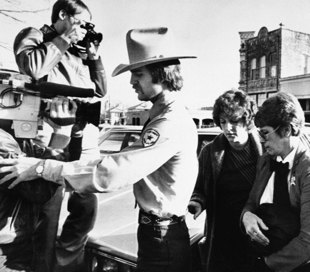  In this Feb. 16, 1984, file photo, Genene Jones, second right, is escorted into Williamson County Courthouse in Georgetown, Texas. Jones, a former nurse who's been serving a 99-year prison sentence since 1984 for the fatal overdose of an infant in her care, is due for early release in March 2018. A grand jury indicted her on Thursday, May 25, 2017, in the death of another infant as prosecutors try to keep her behind bars. (AP Photo/Ted Powers, File)
