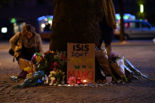 Messages and floral tributes are seen in Albert Square in Manchester, northwest England on May 23, 2017, in solidarity with those killed and injured in the May 22 terror attack at the Ariana Grande concert at the Manchester Arena. Twenty two people have been killed and dozens injured in Britain's deadliest terror attack in over a decade after a suspected suicide bomber targeted fans leaving a concert of US singer Ariana Grande in Manchester. British police on Tuesday named the suspected attacker behind the Manchester concert bombing as Salman Abedi, but declined to give any further details. / AFP PHOTO / Ben STANSALL