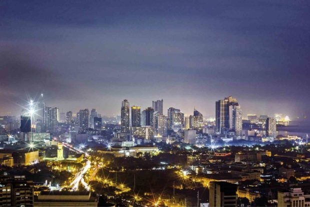 Metro Manila skyline at night. STORY: Metro Manila COVID growth rate dips, could peak by July – OCTA