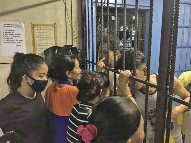 Visiting time is a little tricky at a Pasay police jail with inmates and visitors alike waiting for their turn to stand right next to the steel bars for a chance to see and talk to their loved ones. —Dexter Cabalza