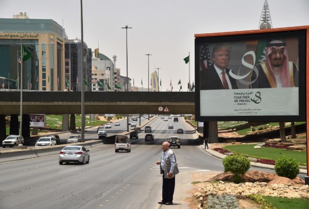 A giant billboard bearing portraits of US President Donald Trump and Saudi Arabia's King Salman, is seen on a main road in Riyadh, on May 19, 2017.  Trump, on his first foreign trip since taking office in January, will tell Muslim leaders of his "hopes for a peaceful vision of Islam" as he seeks support for the war against radical Islamists, Washington has said. / AFP PHOTO / GIUSEPPE CACACE
