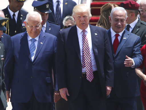 US President Donald Trump walks on his arrival accompanied by the Israeli President Rueben Rivlin, right, and Prime Minister Benjamin Netanyahu in Tel Aviv, Monday, May 22,2017. (AP Photo/Oded Balilty)