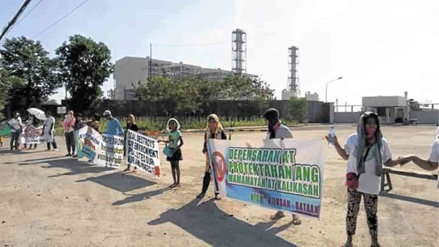 Anticoal power plant advocates form a human chain in front of a coal-fired power plant in the province of Bataan to express their continued opposition to the operations of highly polluting sources of energy. —CONTRIBUTED PHOTO