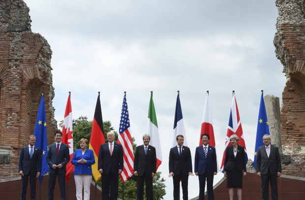 G7 leaders, from left, European Council President Donald Tusk, Canadian Prime Minister Justin Trudeau, German Chancellor Angela Merkel, U.S. President Donald Trump, Italian Prime Minister Paolo Gentiloni, French President Emmanuel Macron, Japanese Prime Minister Shinzo Abe, British Prime Minister Theresa May, and European Commission President Jean-Claude Juncker, pose for a family photo at the Ancient Greek Theater of Taormina, Friday, May 26, 2017, in Taormina, Italy. (Sean Kilpatrick /The Canadian Press via AP)