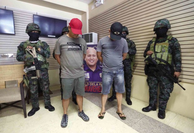 Two of the 11 Malabon policemen tagged in the kidnap-for-ransom complaint—P03 Bernardino Pacoma and SPO3 Jerry dela Torre—are presented in Camp Crame on Saturday. —Lyn Rillon 