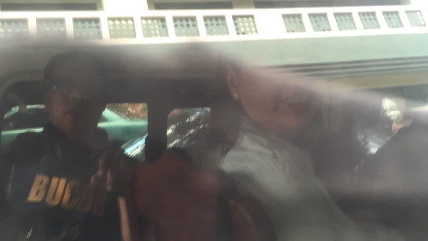 Janet Lim Napoles  (right) is partially visible from inside the Bucor ambulance that took her to the Sandiganbayan on Wednesday, May 10, 2017. MARC JAYSON CAYABYAB