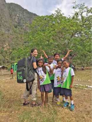 Private donor Leah Quimson poses with children carrying School-in-a-Bag packages which will  bring digitized learning to children in remote areas. — CONTRIBUTED PHOTO