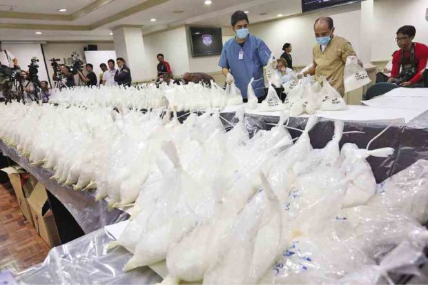 National Bureau of Investigation personnel display hundreds of plastic bags containing kilos of shabu, part of a P5-billion shipment seized from a warehouse in Valenzuela City, on Friday based on a tip from Chinese authorities. —MARIANNE BERMUDEZ