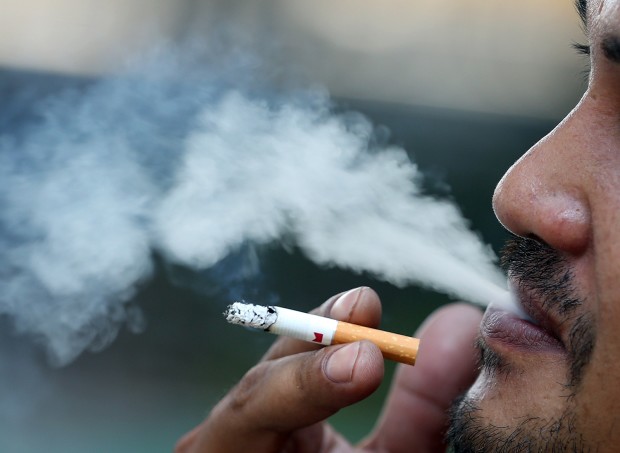 Closeup of man smoking. STORY: Expert discusses lung cancer symptoms, effects, causes