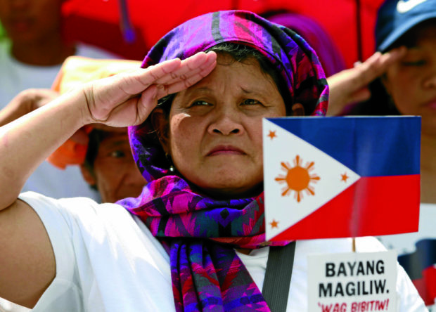 Woman saluting Marawi siege dead on Independence Day 2017. STORY: Foundation offers Independence Day perks for AFP troops, kin