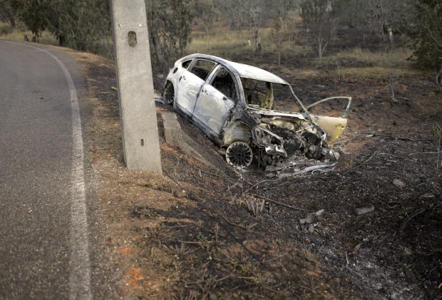 Burned car after forest fires in Portugal - 19 June 2017
