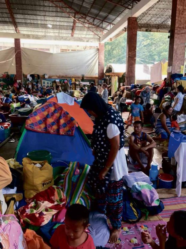 CROWDED People who fled war-torn Marawi City occupy overcrowded and unsanitary evacuation centers in Iligan City, including this shelter in Barangay Buru-un. —ALLAN NAWAL