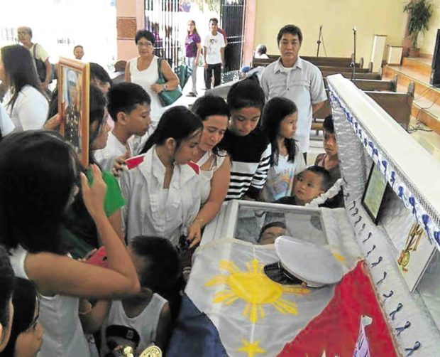 Relatives and friends of Marine Cpl. John Romulo C. Garcia bid farewell to the hero of San Miguel town who, along with 12 other Marines, was killed in a clash with members of the  Maute group in Marawi City. —RIZALITA PETALCORIN/CONTRIBUTOR