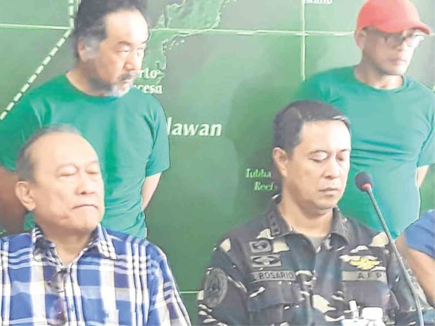 Palawan Gov. Jose Chavez Alvarez (left, seated) and Lt. Gen. Raul del Rosario, Western Command chief, present Hiroyuki Nagahama (left, standing) and another suspect in the killing of two Japanese tourists in the province.  —REDEMPTO ANDA