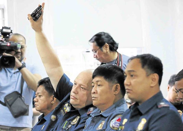 Supt. Marvin Marcos (hand raised) and other police officers charged with killing Albuera Mayor Rolando Espinosa Sr. at a preliminary investigation hearing in the Department of Justice last December —INQUIRER PHOTO