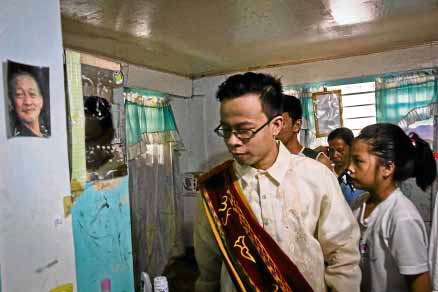 GRADUATION SPEAKER While mourning the death of his father, Arnel Villancio Jr. gets ready to attend and speak during the graduation ceremony at the University of the Philippines Los Baños in Laguna province. —CHRIS QUINTANA/CONTRIBUTOR