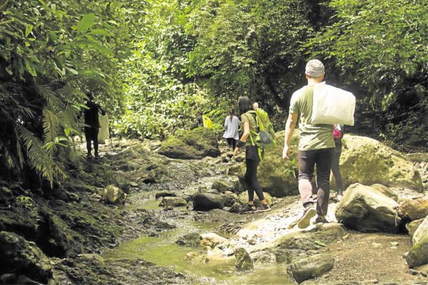 Volunteers trek through the Buhisan watershed forest reserve in Cebu City in search of trash left by visitors. —CONTRIBUTED PHOTO