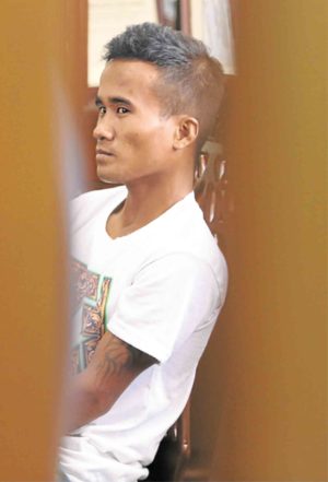 Construction worker Carmelino Ibañez inside a police station in San Jose del Monte City, Bulacan province,  after confessing to the massacre of members of the Carlos family and being addicted to drugs. Tests, however, showed he was negative for drug use. —INQUIRER PHOTO