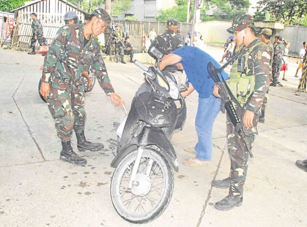 Army reservists help man a checkpoint in Iligan City   RICHEL V. UMEL