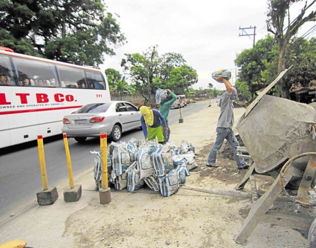 Vehicles slow down along this section of Maharlika Highway in Sariaya town in Quezon province due to a road widening project.  —DELFIN T. MALLARI JR.