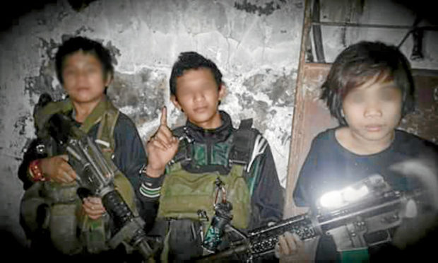 IS IT HE? Rowhanisa Abdul Jabar says one of the armed child fighters (left) with the Maute group resembles her son, Ram-Ram, who was kidnapped when he was 3 years old. —FACEBOOK PHOTO