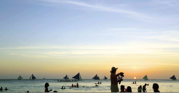 Tourists enjoy the sunset on Boracay Island. —MARK ALVIC ESPLANA
