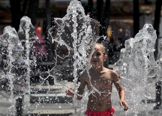 Child plays in fountain - Bucharest, Romania - 3 Aug 2017