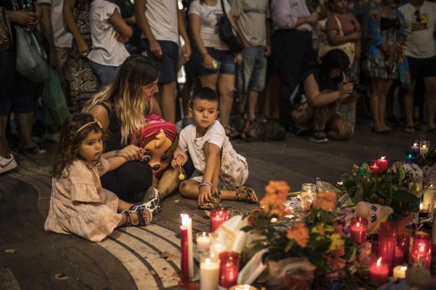 Woman and kids at memorial to Barcelona attack victims - 18 Aug 2017